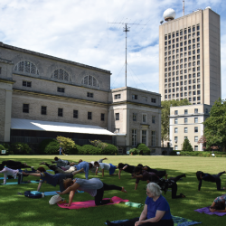 Participants in Yoga practice outside the Green building
